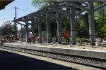 WORKER SMOOTHING CONCRETE ON PLATFROM